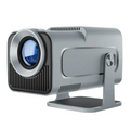 HY320 mini projector next to a 13‑inch laptop to illustrate its compact portable size.
