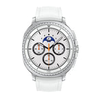 Samsung Galaxy Watch8 Classic White next to its retail box and charging cable on table.